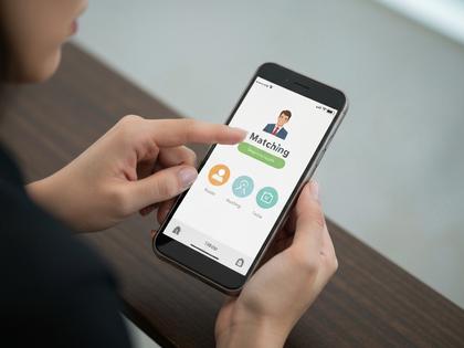 スマートフォンでマッチングアプリを操作する女性の手元