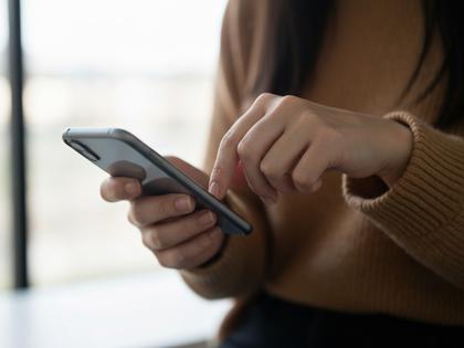 スマホでメッセージを送信している女性の手元アップ