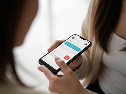 スマホでマッチングアプリを操作している20代女性の手元アップ写真