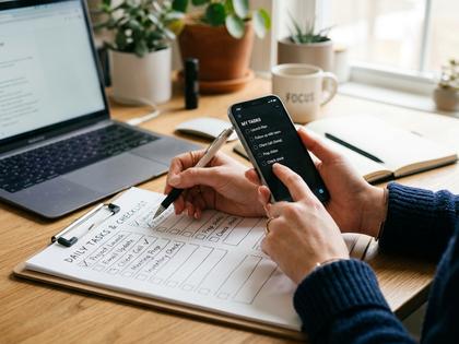 チェックリストとスマホを照らし合わせる女性の手元