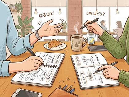 カフェで打ち合わせをする2人のビジネスパーソン。意見を出し合い、ノートで思考を整理している。