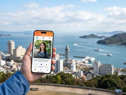 瀬戸内海と高松の街並みを背景にスマホを操作する女性のイメージ